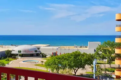 a view of a building with the ocean in the background at Tivoli Apt8 with Pool&Garage in Vilamoura