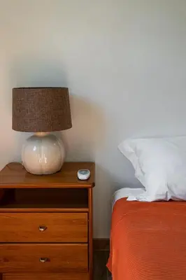 a lamp on a night stand next to a bed at The Albufeira Concierge - Villa Balaia Sun Terrace in Albufeira