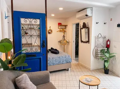 a bedroom with a blue door with a bed in it at Old Fisherman's Corner 18 - Centro Old Town Albufeira in Albufeira