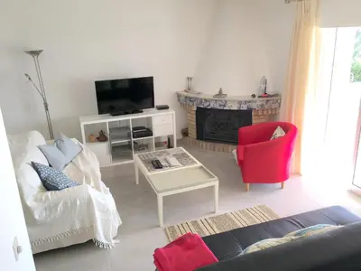 a living room with a couch and a fire place at Charming House with Pool in Faro in Faro