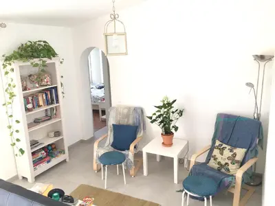 a living room with two chairs and a table at Charming House with Pool in Faro in Faro