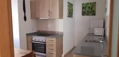 a small kitchen with a stove and a sink at Sun Apartment on the Beach in Albufeira