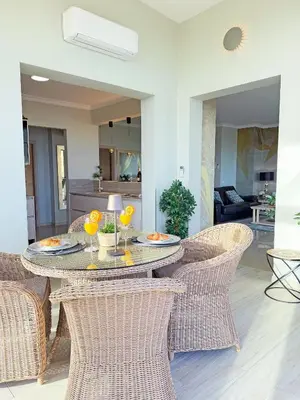 a living room with a couch and a tv at AlbufeiraOrada SunSet Penthouse by Be Cherish in Albufeira