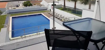 a balcony with a swimming pool on a house at Villa Amazing View - S in Albufeira