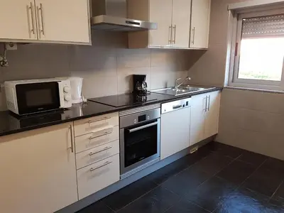 a kitchen with a sink and a microwave at Villa Amazing View - S in Albufeira
