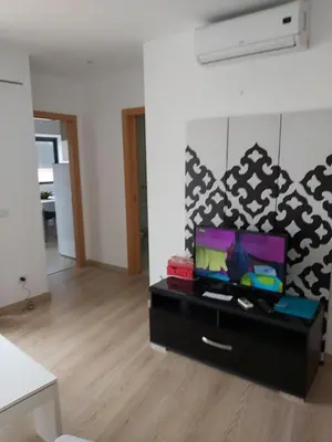a living room with a table with a tv on it at Terrace apartament on the Sea in Albufeira