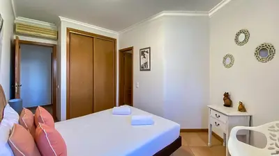 a bathroom with a sink and a toilet and a mirror at T3 Marina Sol Vilamoura by HsRentals in Vilamoura