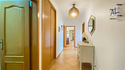 a bedroom with a bed and a desk and a window at T3 Marina Sol Vilamoura by HsRentals in Vilamoura