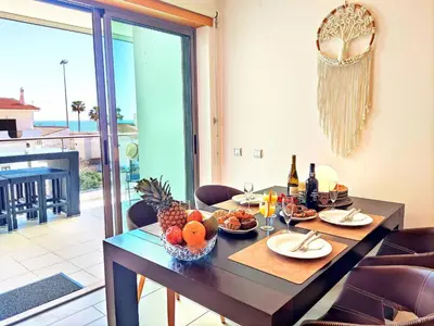 a dining room table with a bowl of fruit on it at Beach Condo with Atlantic Ocean View by BeCherish in Olhos de Água