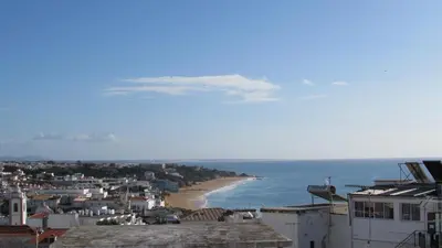 a bedroom with a bed with two bowls on it at Apartamentos Julieta in Albufeira