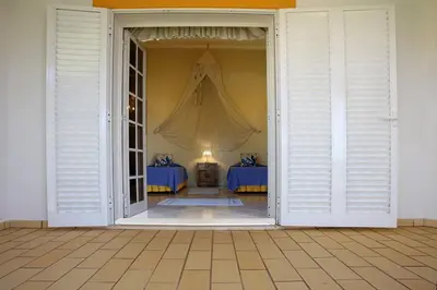 an open door to a room with two beds at Villa Jumar in Albufeira