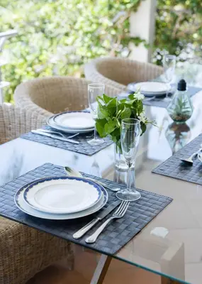 a table with plates and utensils on a table at Villa Sara in Quarteira