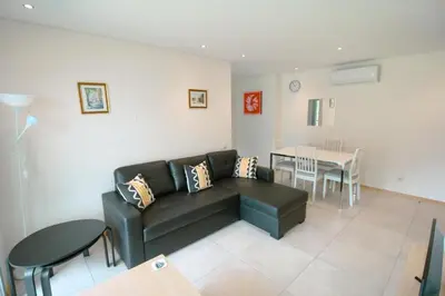 a living room with a couch and a table at 2 Bed apartment with Roof Top Pool, close to Falesia Beach AT10 in Albufeira