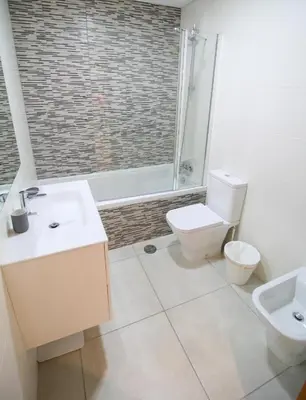 a bathroom with a toilet and a sink and a shower at 2 Bed apartment with Roof Top Pool, close to Falesia Beach AT10 in Albufeira
