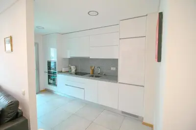 a kitchen with white cabinets and a counter top at 2 Bed apartment with Roof Top Pool, close to Falesia Beach AT10 in Albufeira
