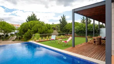 a house with a swimming pool and a deck at Apartment Luisa in Vale do Lobo
