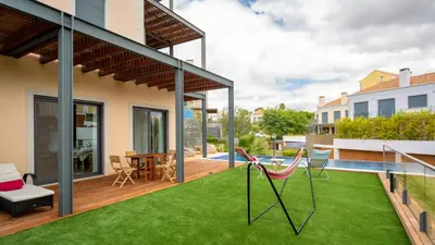 a balcony with a lawn and chairs on it at Apartment Luisa in Vale do Lobo
