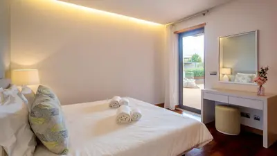 a bedroom with a bed and a desk and a mirror at Apartment Luisa in Vale do Lobo