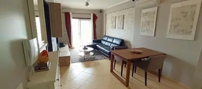 a living room with a couch and a table at Mshomes II in Albufeira
