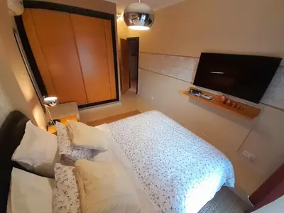a bedroom with a bed and a flat screen tv at Mshomes II in Albufeira