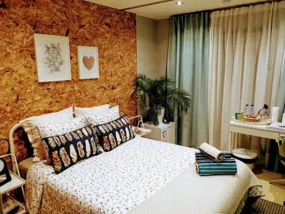 a bedroom with a bed with a white comforter at Mshomes II in Albufeira