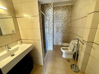a bathroom with a toilet and a sink and a shower at Villa OceanKokia in Albufeira
