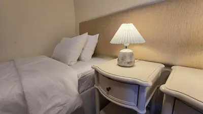 a bedroom with a bed and a lamp on a night stand at Villa OceanKokia in Albufeira