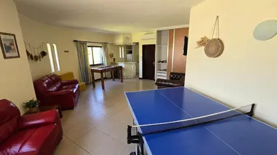a living room with a ping pong table in it at Villa OceanKokia in Albufeira