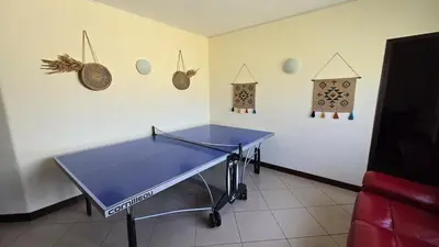 a blue ping pong table in a room with decorations at Villa OceanKokia in Albufeira