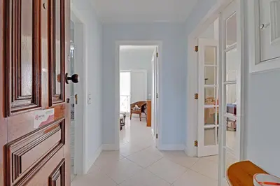 a hallway with white walls and a white floor at Vilamoura Main Avenue by Homing in Vilamoura