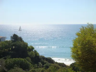 a sail boat in the ocean with acean at Bicos 101 by Check-in Portugal in Albufeira