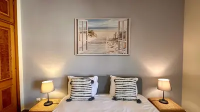 a bedroom with a bed with two lamps at Bicos 303 by Check-in Portugal in Albufeira