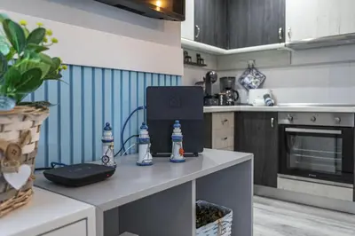 a kitchen with a table with a laptop on it at Alcharb - Modern Studio - Vilamoura center in Vilamoura