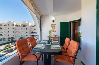 a balcony with a table and chairs on a balcony at Albufeira Salgados Beach 1 by Homing in Albufeira