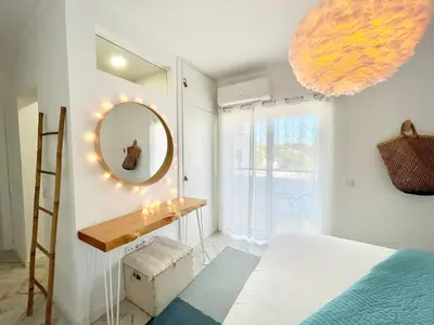 a bedroom with a large bed and a bathroom at Mamma Mia CITY CENTER in Vilamoura