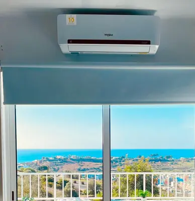 a window with a view of the ocean at Ocean View Skyline Apartment ‚Hakuna Matata‘ in Albufeira