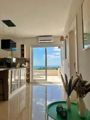 a kitchen with a view of the ocean from a room at Ocean View Skyline Apartment ‚Hakuna Matata‘ in Albufeira
