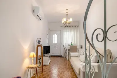 a living room with a couch and a table at Typical Fisherman's Cottage with amazing sea views! in Albufeira