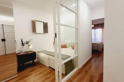 a white room with a bed and a window at Lindo apartamento junto à praia e à Marina de Vilamoura com Piscina e Wi-Fi in Quarteira