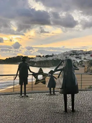 a man and a woman standing on the beach at Sunset View Apartment - 22 in Albufeira