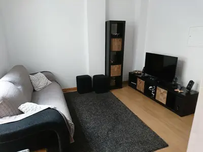 a living room with a couch and a flat screen tv at Faro City Center Apartment I in Faro