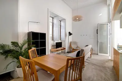 a dining room with a wooden table and chairs at Casa Vermelha I in Faro