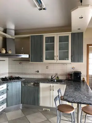 a stainless steel refrigerator sitting in a kitchen at CASA PANORAMICA VUE MER 8 a 10 Personnes in Boliqueime