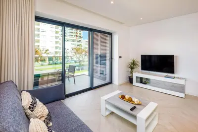 a living room with a couch and a table at Apartamento Porlamar in Quarteira