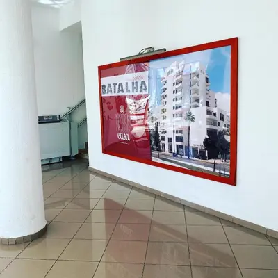 a picture of a building on a wall in a room at Castelo I in Quarteira