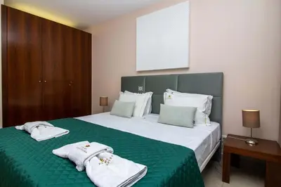a hotel room with two beds and a tv at Herdade dos Salgados Beach Apartment Dalma Delux in Albufeira