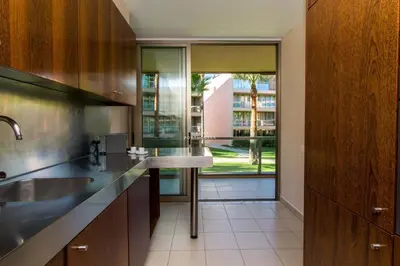 a kitchen with a sink and a large window at Herdade dos Salgados Beach Apartment Dalma Delux in Albufeira