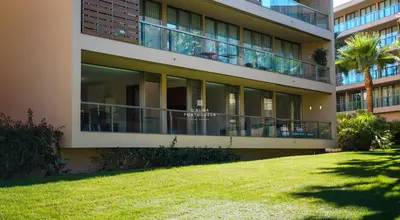a large building with a lawn in front of it at Herdade dos Salgados Beach Apartment Dalma Delux in Albufeira
