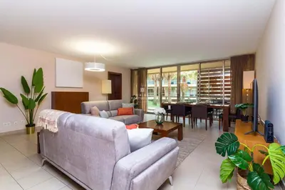 a living room with a couch and a table at Herdade dos Salgados Beach Apartment Dalma Delux in Albufeira