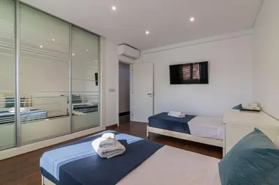 a bedroom with a bed with towels on a table at Vilamoura Premium Apartment With Pool by Homing in Vilamoura